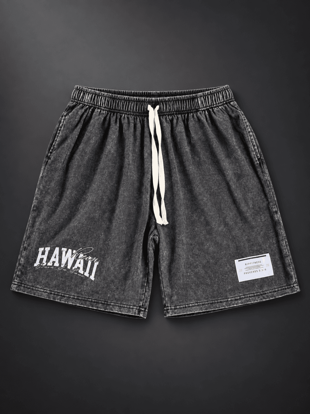 Front studio view of Vintage Black Japanese Hawaiian 7-inch shorts with cream drawstrings and Hawaii graphic.