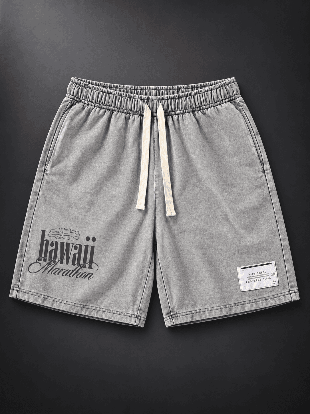 Front studio view of Vintage Gray Japanese Hawaiian 7-inch shorts with cream drawstrings and Hawaii Marathon artwork.